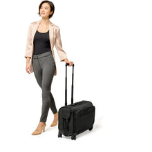 Load image into Gallery viewer, Briggs & Riley Baseline Wide Carry On Wheeled Garment Spinner - lifestyle wheeling