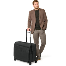 Load image into Gallery viewer, Briggs & Riley Baseline Deluxe Wardrobe Spinner - lifestyle wheeling
